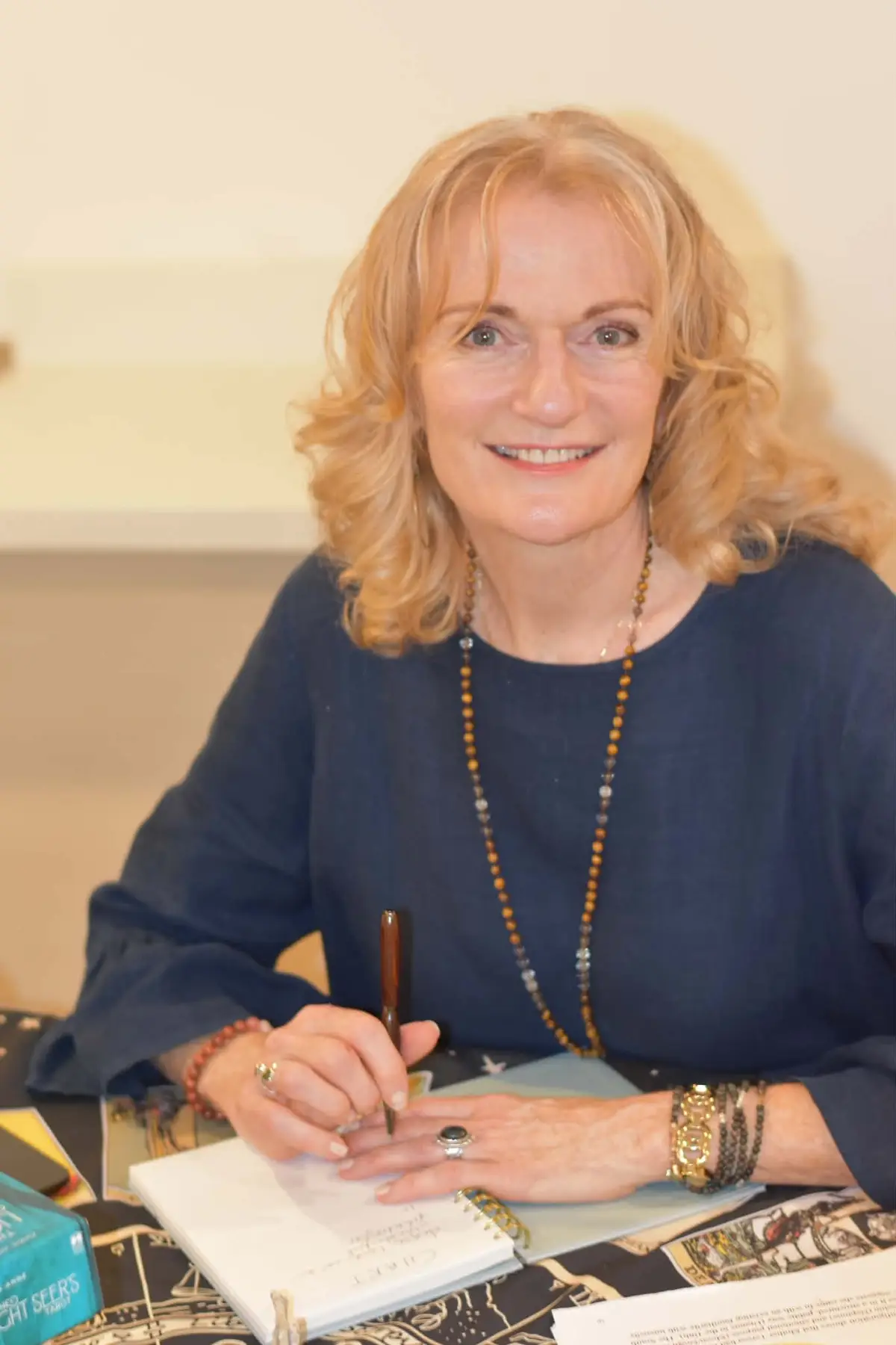 Ginger at her desk, reading a printed birth chart
